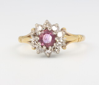 An 18ct yellow gold ruby and diamond cluster ring, size N 1/2, 4.3 grams