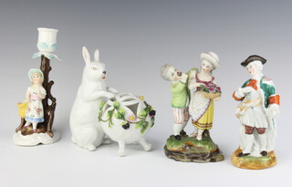 A Continental porcelain figure group of a boy and girl with basket of roses 14cm h, the base with roundell mark (damage to one of the roses), a ditto figure of a standing gentleman 13cm, ditto porcelain candlestick in the form of a girl 16cm and a porcelain figure of a rabbit by a basket 13cm (chip to ear) 