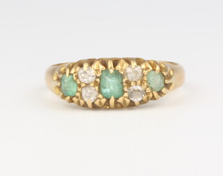 An 18ct yellow gold 3 stone emerald and diamond ring, 3.5 grams, size N