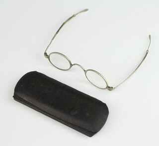 A pair of Georgian silver coloured metal wig spectacles, cased