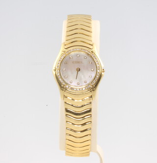 A lady's 18ct yellow gold diamond set Ebel wristwatch on an articulated bracelet numbered E8003F15A035712, 95.7 grams 