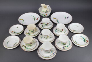 A Victorian 33 piece porcelain tea service with butterfly decoration comprising 2 bread plates, 11 tea plates (5 f), 11 saucers (2 cracked), 6 tea cups (4 cracked) and a slop pail