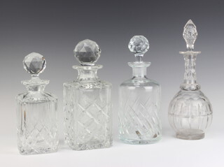 Two cut glass spirit decanters and stoppers, a cylindrical decanter and stopper (possibly wrong stopper) and a club shaped decanter and stopper 