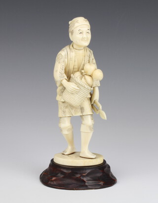 A Japanese Meiji period carved ivory figure of a standing gardener with basket 18cm 