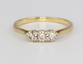 An 18ct yellow gold 3 stone diamond ring, approx. 0.15ct, size O 1/2