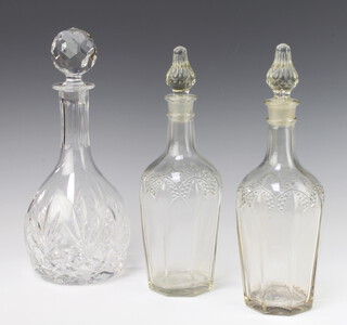 A cut glass mallet shaped decanter and stopper 29cm and 2 French pressed glass decanters and stoppers 