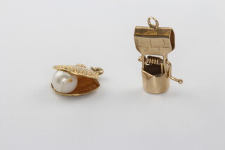 A 9ct yellow gold wishing well charm and a ditto oyster charm, 2 grams