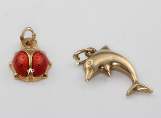 A 9ct yellow gold ladybird charm and a ditto dolphin charm 1.2 grams 