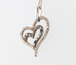 A 9ct white gold black and white diamond pendant and chain 2.5 grams 