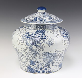 A Chinese blue and white urn and cover of squat form, decorated carp 37cm x 34cm 