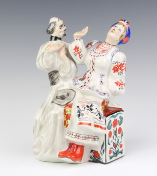 A Soviet Russian porcelain figure group of a seated couple, the base marked K, 21cm h 