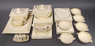 A 36 piece Clarice Cliff "The Biarritz" pattern dinner service comprising 2 rectangular meat plates (1 with crazing), 6 rectangular plates (some crazing and rubbing to the gilding) 6 side plates, 6 tea plates (1 cracked), 2 tureens (1 cracked), 2 sauce boats (1 with chip), 4 piece cruet and stand (salt chipped), 6 twin handled soup bowls (1 cracked), 5 saucers 