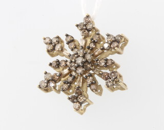 A 9ct yellow gold diamond set snowflake pendant, 2.7 grams 