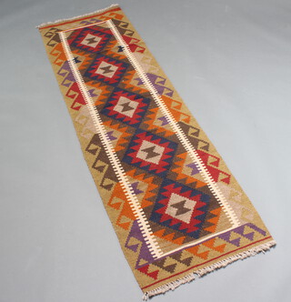 A red, blue and brown ground Mashwani Kilim runner with all over geometric design 203cm x 60cm 