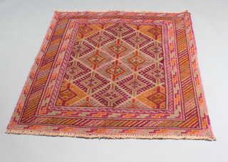 A brown and purple ground Gazak rug with diamond decoration to the central ground 120cm x 117cm 