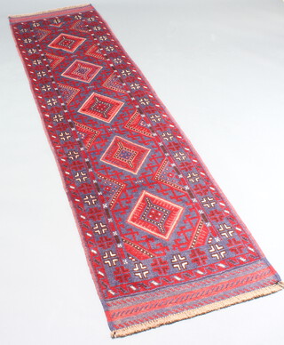 A blue and red ground Mashwani runner with 5 diamonds to the centre and multi row border, 256cm x 63cm 