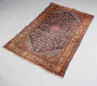 An Afghan blue and tan ground rug with diamond shaped medallion to the centre within a multi row border 148cm x 100cm 