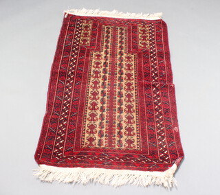 A red, brown and black ground Belouche prayer rug 132cm x 76cm 