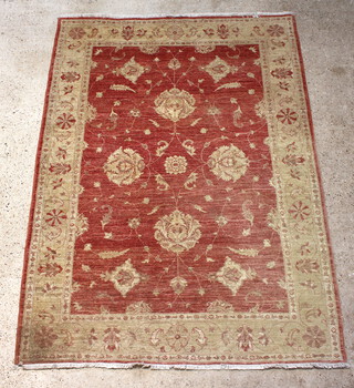 A contemporary Caucasian style yellow and terracotta rug with floral fields 236cm x 173cm 