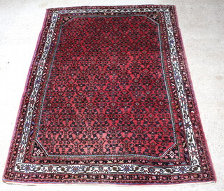 A red and blue ground Persian carpet with all over geometric design within a multi row border 289cm x 206cm 