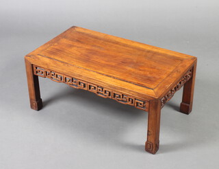A Chinese rectangular hardwood opium table with pierced apron, raised on square supports 30cm x 71cm x 41cm 