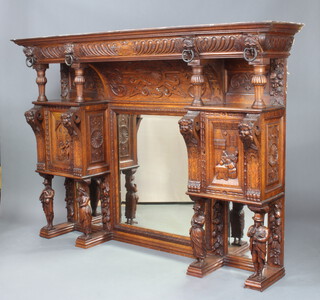 A Victorian heavily carved oak rectangular 3 section over mantel mirror with moulded and arched cornice, recesses and lion mask decoration, pair of cupboards enclosed by panelled doors supported by 4 figures of standing musicians 136cm h x 190cm w x 39cm d  