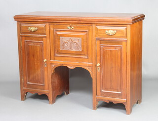 An Edwardian walnut sideboard, the centre fitted a fall front above a recess flanked by drawers above cupboard, enclosed by panelled doors 88cm h x 121cm w x 43cm d  