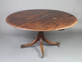 A Regency circular snap top breakfast table raised on a gun barrel column and tripod base, brass caps and casters 71cm h x 145cm diam. 
