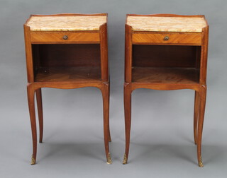 A pair of French Kingwood bedside cabinets with brown veined marble tops, fitted a drawer above a recess and raised on cabriole supports 72cm h x 40cm w x 31cm d 