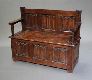 An oak hall settle with hinged lid and linen fold decoration 90cm h x 112cm w x 40cm d 