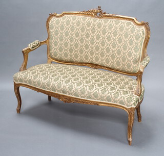 A French carved gilt hardwood 2 seat salon sofa upholstered in green and gold sculptured material, 101cm h x 117cm w x 53cm d 