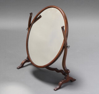 A Sheraton style oval plate dressing table mirror contained in a mahogany swing frame 56cm h x 43cm w x 24cm d 