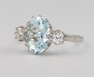 A platinum, aquamarine and diamond 3 stone ring, the centre oval aquamarine 4.5ct, flanked by 2 brilliant cut diamonds 0.55ct, size K 