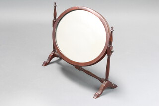 A Georgian style oval plate dressing table mirror contained in a mahogany swing frame on turned supports 46cm h x 50cm w x 20cm d 