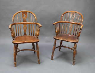 An 18th/19th Century elm Windsor stick and rail back carver chair with crinoline stretcher raised on turned supports together with a later chair (2)

