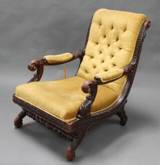 A 19th Century Continental heavily carved ebonised oak show frame open arm chair upholstered in yellow buttoned material, raised on cabriole supports 
