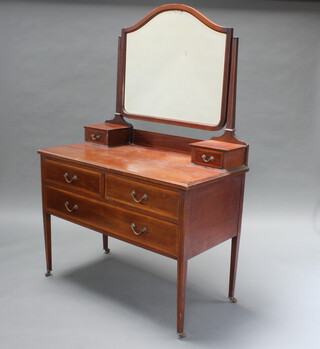An Edwardian inlaid mahogany dressing table with arched shaped mirror, the base fitted 2 glove drawers above 2 short and 2 long drawers, raised on square tapered supports, retailed by Harrods 158cm h x 106cm w x 53cm d 