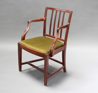 A 19th Century mahogany stick and rail back carver chair with upholstered drop in seat 