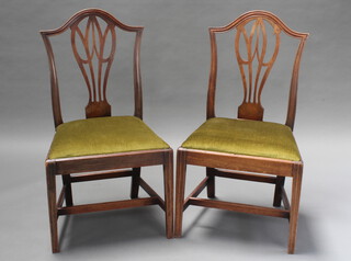 A pair of 19th Century Hepplewhite style mahogany slat back dining chairs with upholstered drop in seats, raised on square supports with box frame stretcher 
