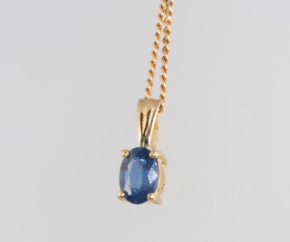 A 9ct yellow gold sapphire pendant and chain 