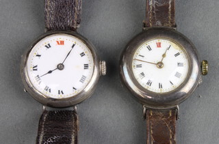 Two lady's silver cased wristwatches on leather straps 