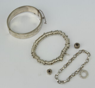 A silver bangle and minor silver jewellery, 100 grams