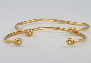 A pair of high carat yellow gold torque bangles, 14 grams