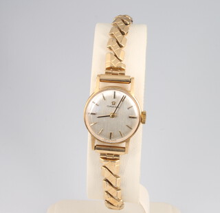 A lady's 9ct yellow gold Omega wristwatch on a gilt expanding bracelet with box 