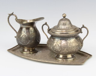 A Persian silver jug, 2 handled sugar bowl and and cover and tray, engraved with flowers and scrolls, 525 grams 