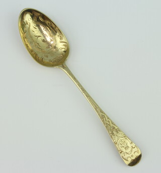 A Victorian silver gilt dessert spoon with chased decoration London 1845, 40 grams