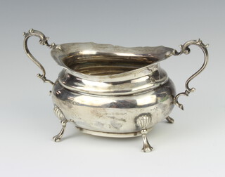 A silver sugar bowl with scroll handle, shell knees and scroll feet, Sheffield 1916 185 grams 