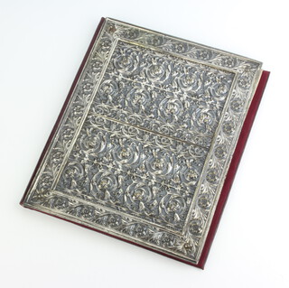 A silver plated repousse mounted blotter binder with formal floral scrolls 