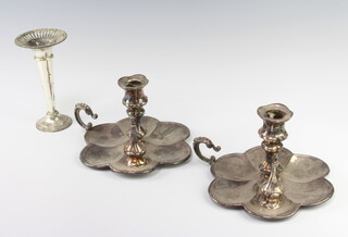 A pair of Victorian silver plated chamber sticks with scallop bases 10cm together with a spill vase 