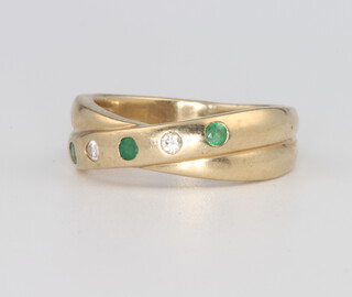 A 9ct yellow gold emerald and diamond crossover ring, 4.1 grams, size J 1/2